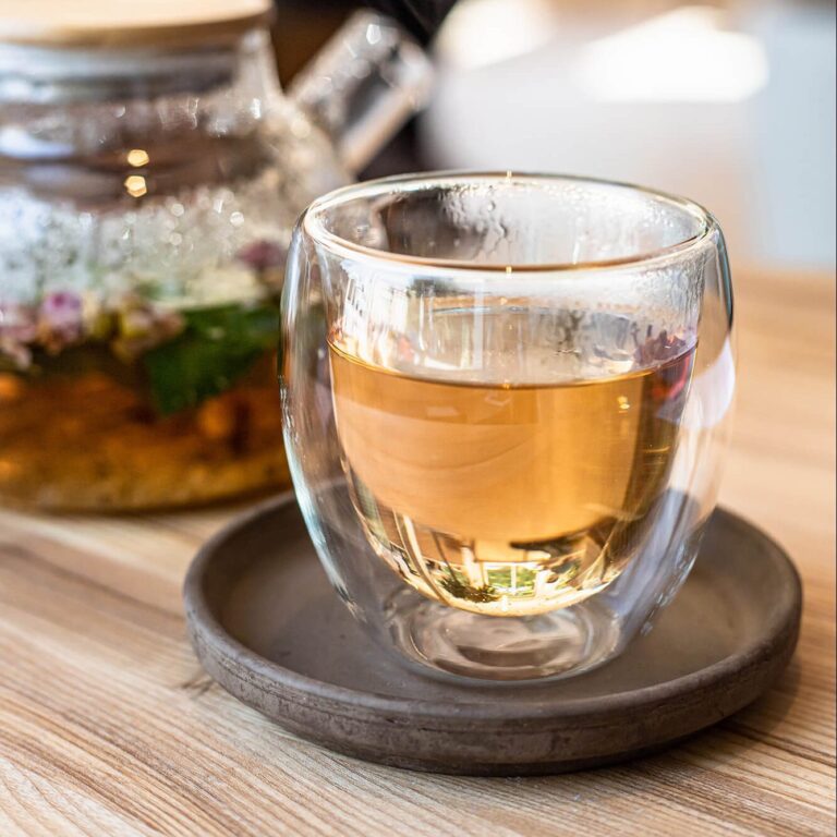 glass-cup-with-green-or-herbal-tea-and-teapot-on-w-2023-11-27-05-30-03-utc-1-e1714544619169.jpg